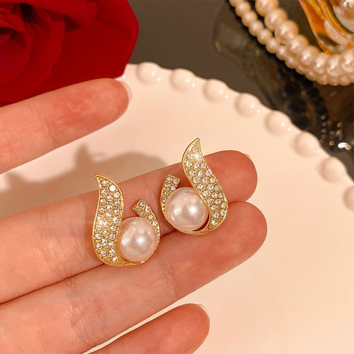 3-7-1.jpg Curved Rhinestone Inlaid Pearl Stud Earrings - Image 1